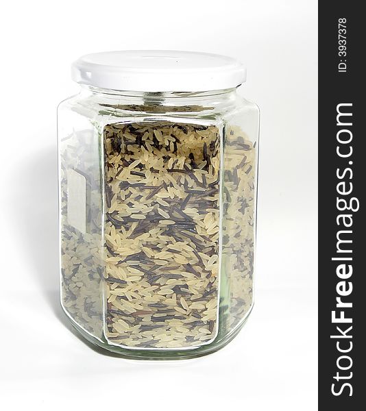 Mix of white and wild black rice in glass jar. Mix of white and wild black rice in glass jar