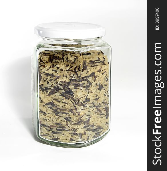 Mix of white and wild black rice in glass jar. Mix of white and wild black rice in glass jar