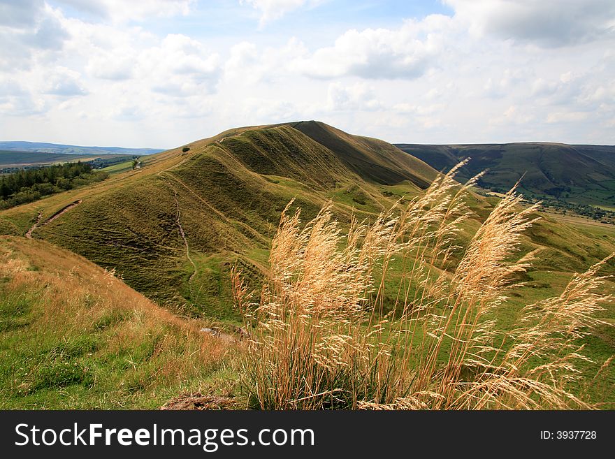 Mam Tor is a 517 m (1696 ft) high peak near Castleton in the High Peak of Derbyshire, England. Mam Tor is a 517 m (1696 ft) high peak near Castleton in the High Peak of Derbyshire, England.