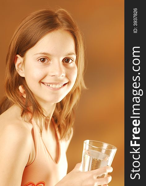 A smiling girl with a glass of water. A smiling girl with a glass of water