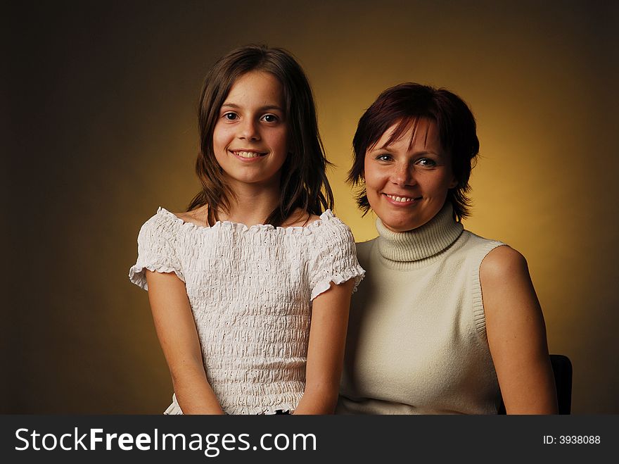 A mother with her daughter over brown background