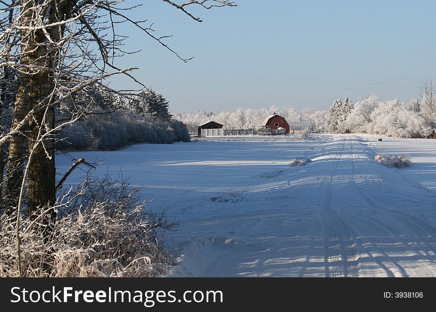 A red barn in a winter farmyard