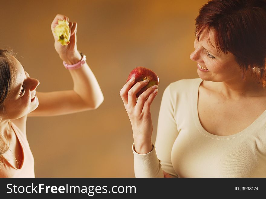 A mother with apple and her daughter. A mother with apple and her daughter