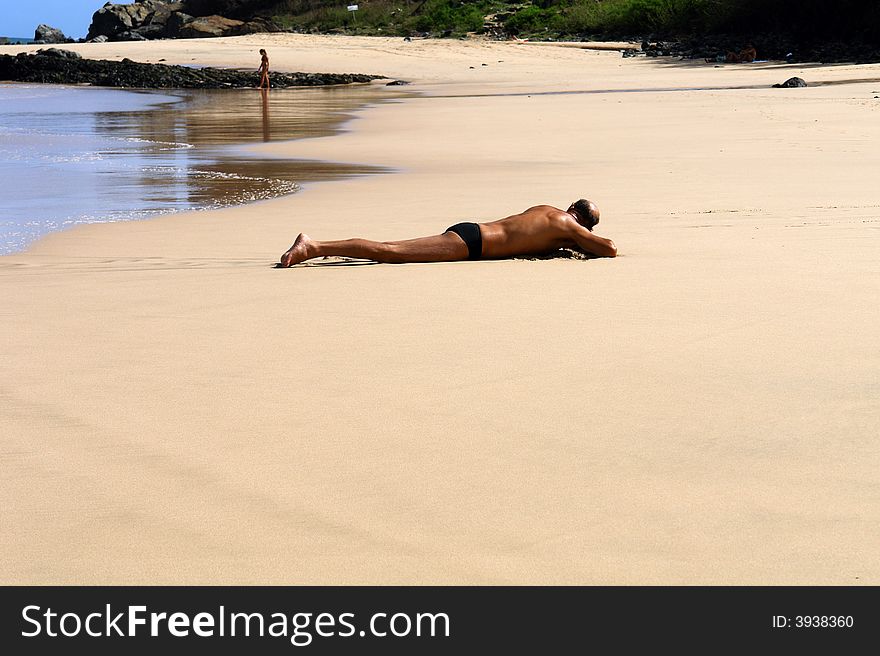 Sunburnt men at beach lying. Sunburnt men at beach lying