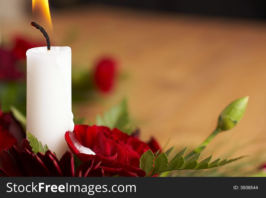 Candles with flower setup on the brown table