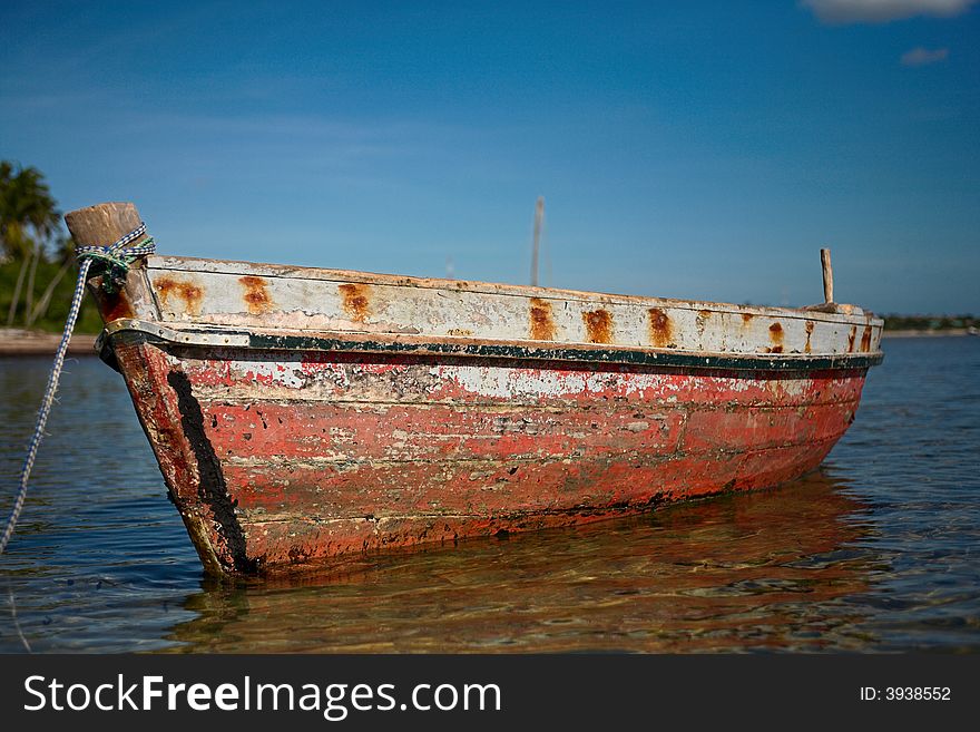 Red dhow or traditional wooden boat on the islands. See the rest in this series.