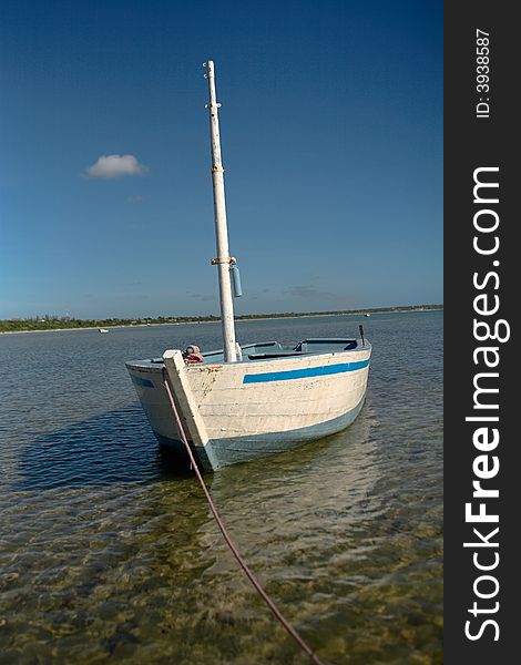 White dhow or traditional wooden boat on the islands. See the rest in this series.