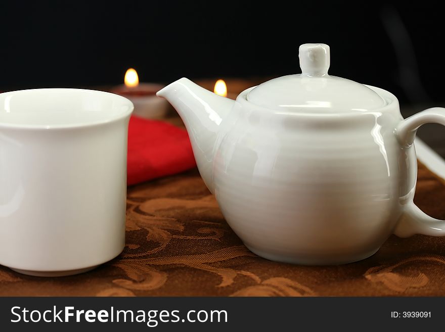 A teacup and mug set on a table for teatime. A teacup and mug set on a table for teatime