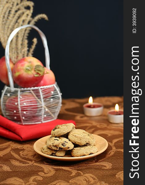 A plate of chocolate chip cookies on a dessert table. A plate of chocolate chip cookies on a dessert table