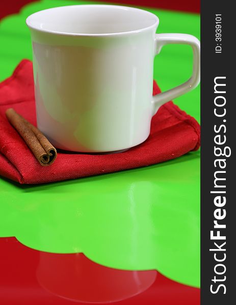 A coffee cup on a red and green table. A coffee cup on a red and green table