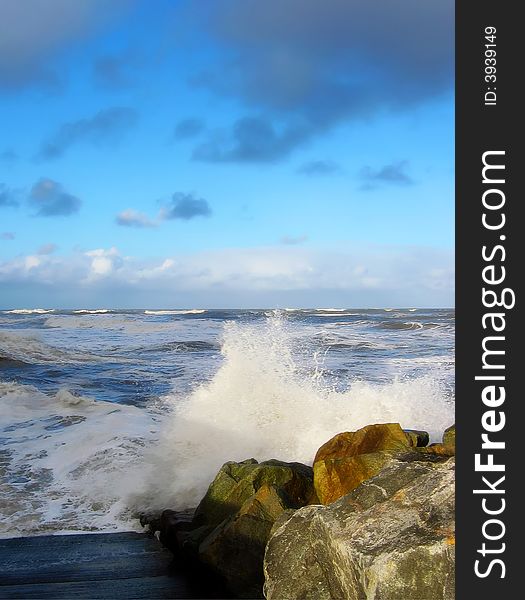 Rough waters splash on rocks at Whitby, North Yorkshire. Rough waters splash on rocks at Whitby, North Yorkshire.