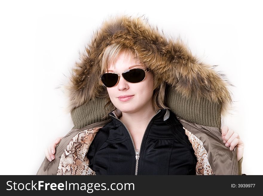 Playful girl with sunglasses in a jacket with a collar of fur