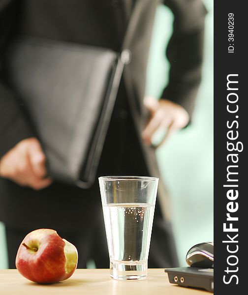 An apple and glass of water. An apple and glass of water
