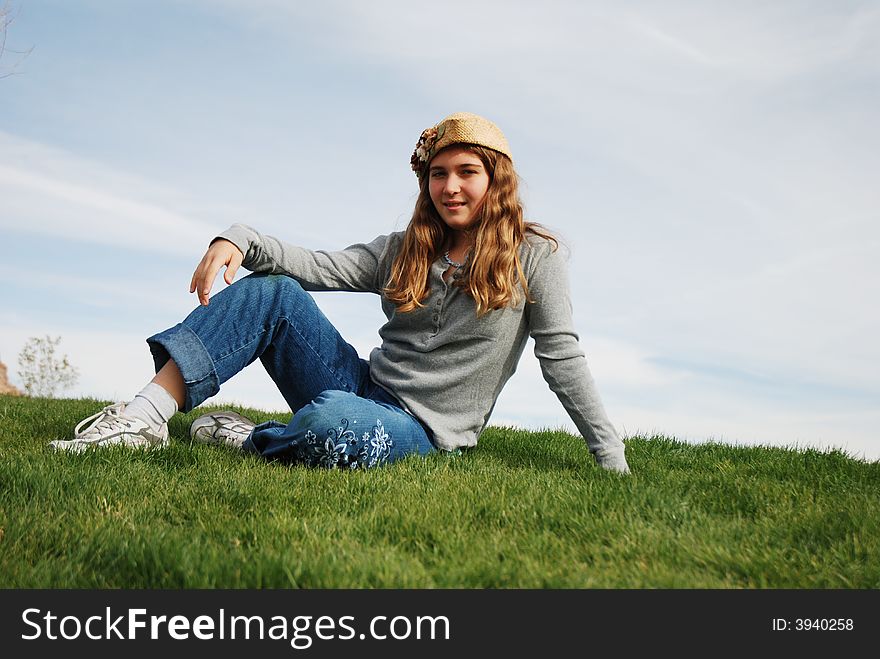 Young girl is enjoying herself in green field