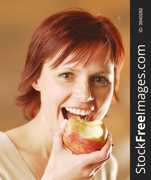 A smiling woman with an apple. A smiling woman with an apple