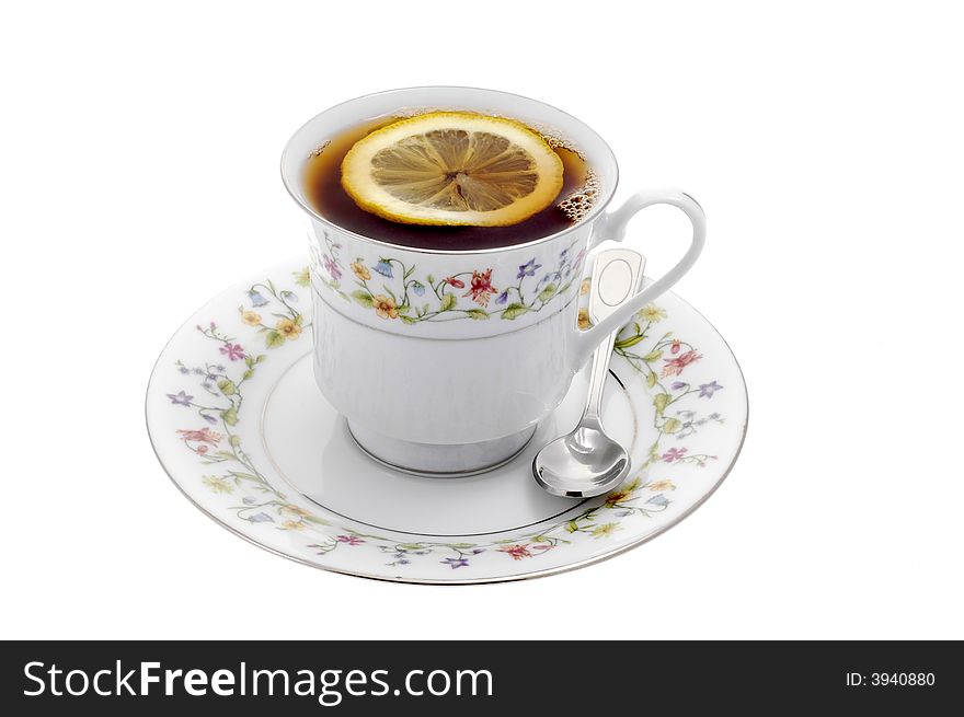 Cup of steeped tea with lemon on a white background.