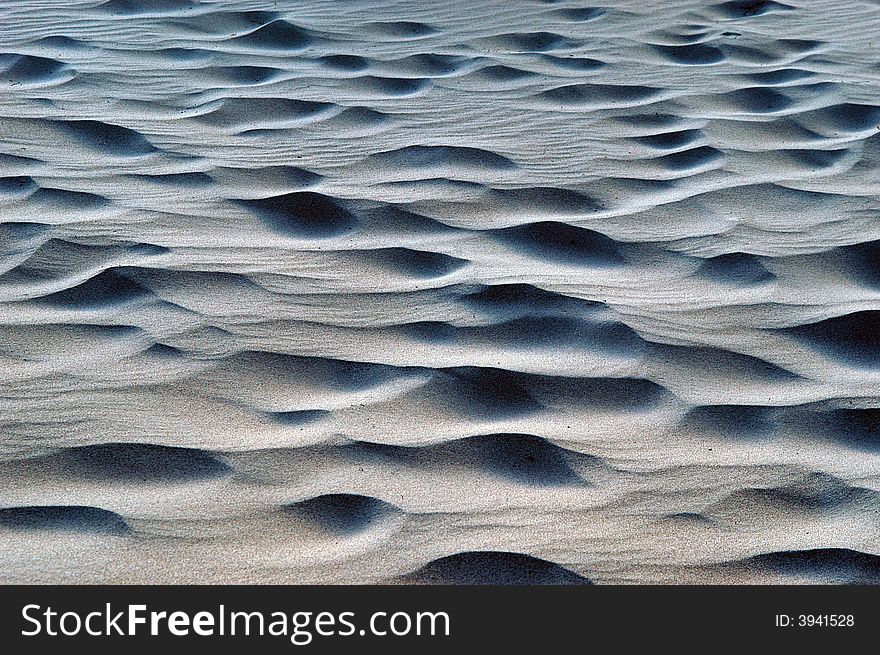 Waves in the sand dunes abstract for backgrounds with shadows. Waves in the sand dunes abstract for backgrounds with shadows