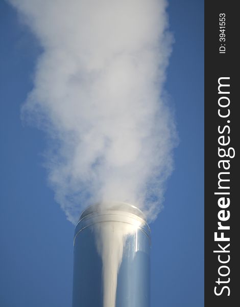 Chimney on a background of a blue smoke