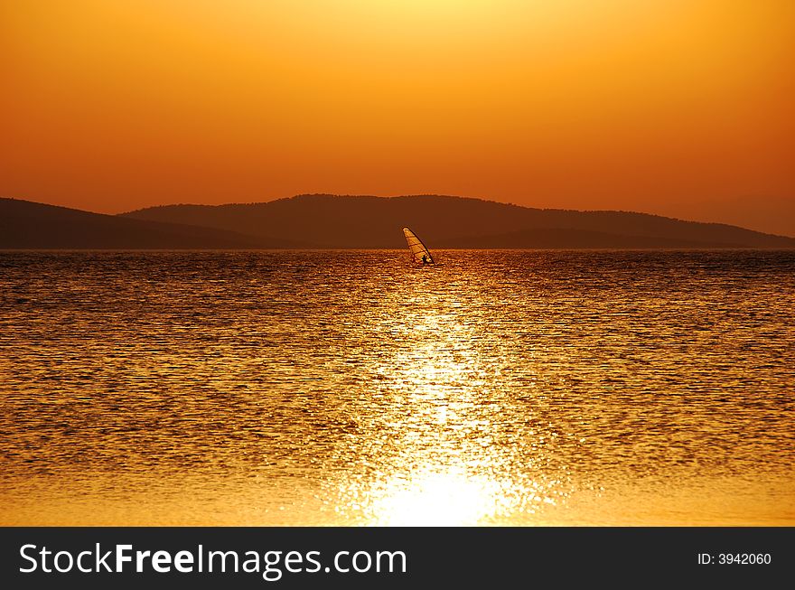 Windsurfing under a warm summer's sun. Windsurfing under a warm summer's sun