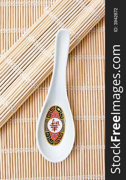 A  soup spoon on bamboo used for rolling sushi.