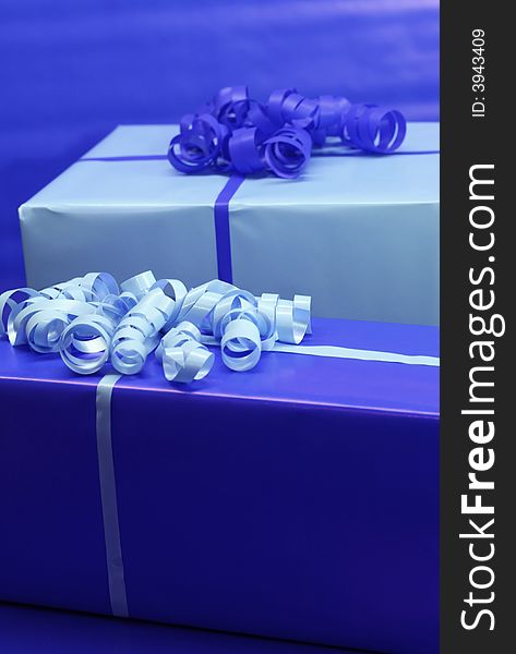 Presents wrapped in blue wrapping paper and ribbon. Presents wrapped in blue wrapping paper and ribbon