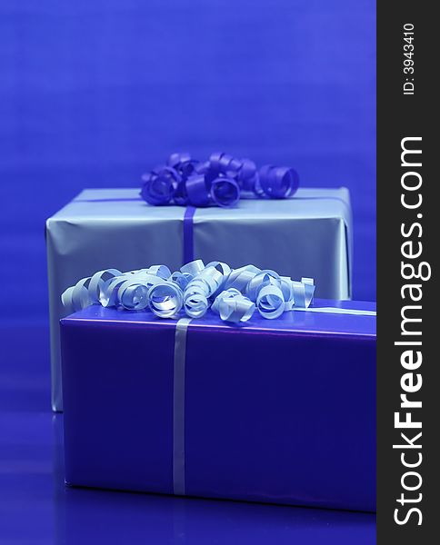 Presents wrapped in light and dark blue paper. Presents wrapped in light and dark blue paper