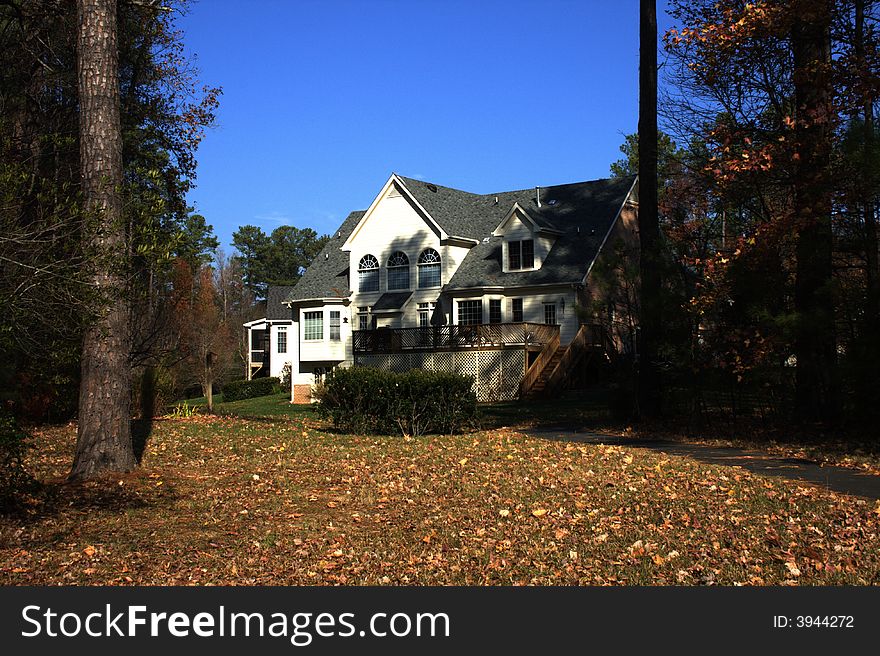 Two-story country house, blue sky. Autumn. Two-story country house, blue sky. Autumn
