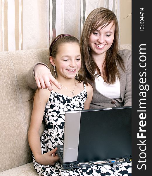 Mother And Daughter Using A Laptop.
