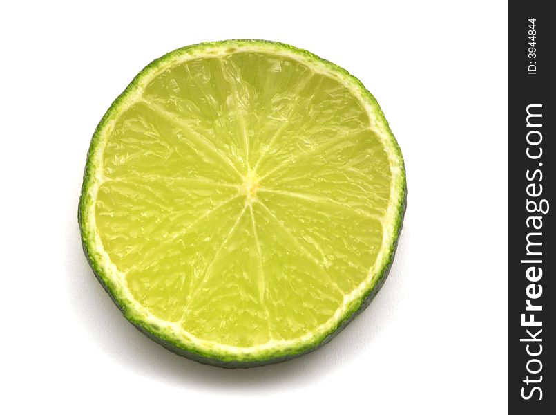 Slice of lime on white background