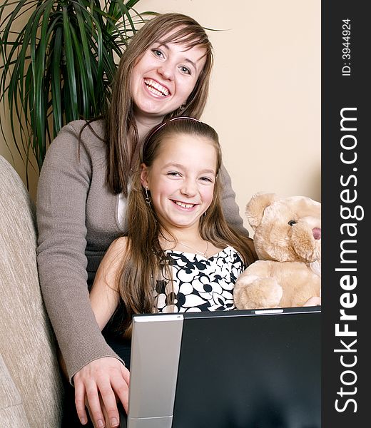 Mother with daughter using a laptop. Have a good fun. Mother with daughter using a laptop. Have a good fun