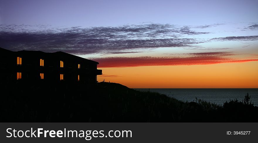 Hotel with lit windows at a sunset. Hotel with lit windows at a sunset