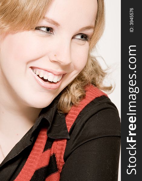 Studio portrait of a young blond curly woman laughing. Studio portrait of a young blond curly woman laughing