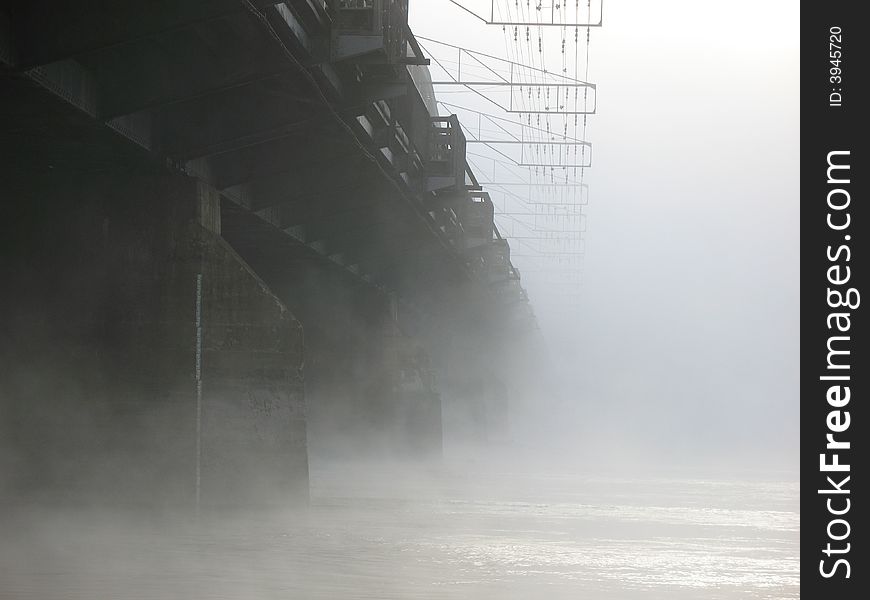 Railway bridge from below on foggy morning. Railway bridge from below on foggy morning