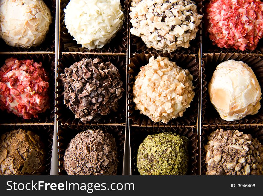 Box of different luxury handmade chocolates - top closeup view