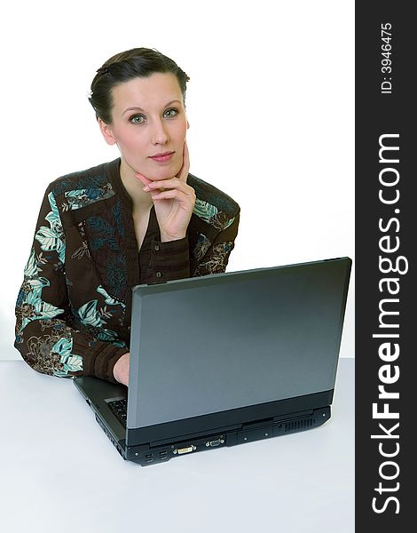 Portrait of an adorable business woman working at her desk with a laptop. Portrait of an adorable business woman working at her desk with a laptop