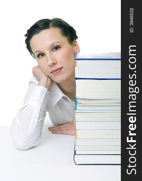 Young woman with piled up books on the desk. Young woman with piled up books on the desk