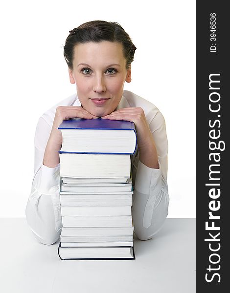 Young woman with piled up books on the desk. Young woman with piled up books on the desk