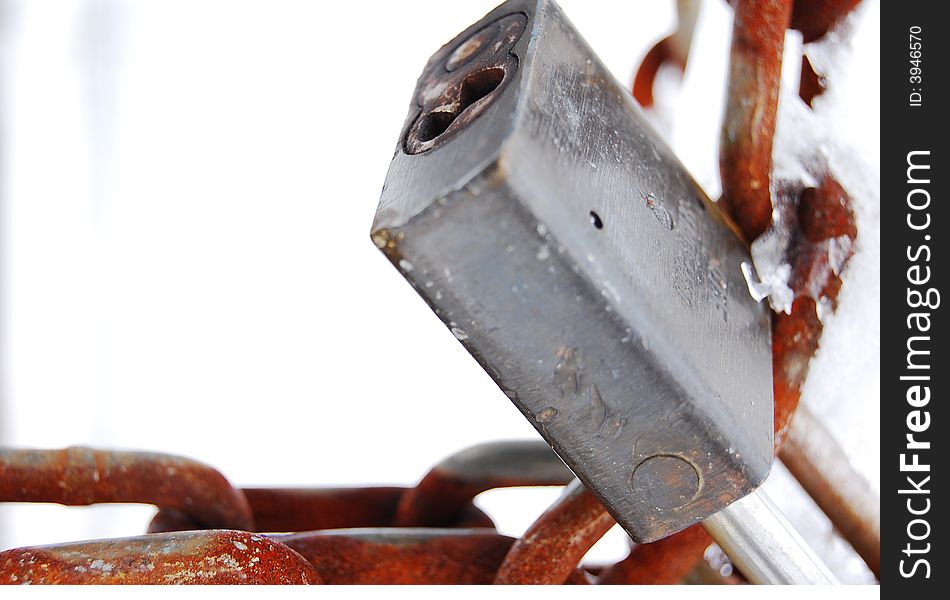 A frozen lock and rusted chain. A frozen lock and rusted chain.