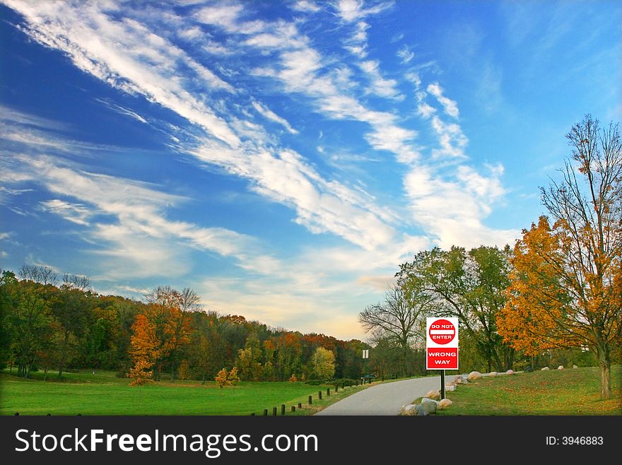 Colorful trees beautiful sky converges at a stop sign