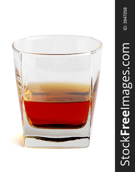 Whiskey in a tetrahedral glass. Object over white. Whiskey in a tetrahedral glass. Object over white.