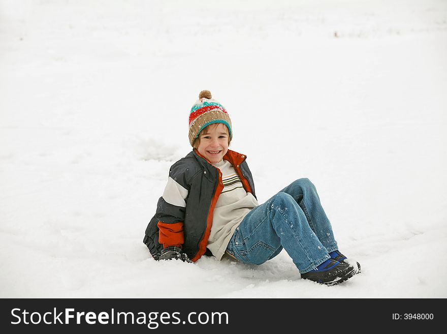 Boy Laying Down Playing in the Snow. Boy Laying Down Playing in the Snow