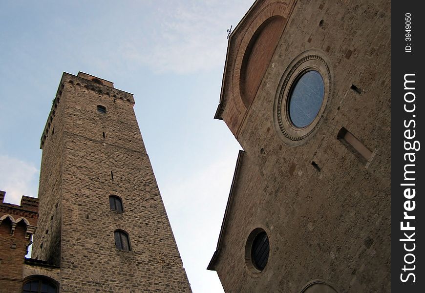 Medieval church and belltower in dusk light, looking up view. Medieval church and belltower in dusk light, looking up view