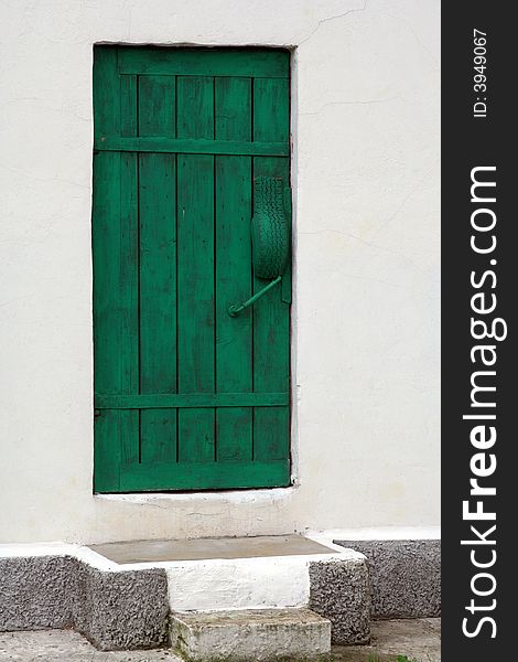 Green door in white wall