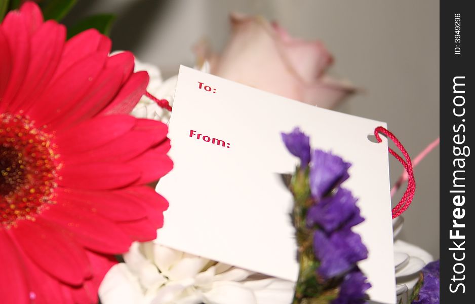 Blank card on a bouquet of flowers. Blank card on a bouquet of flowers