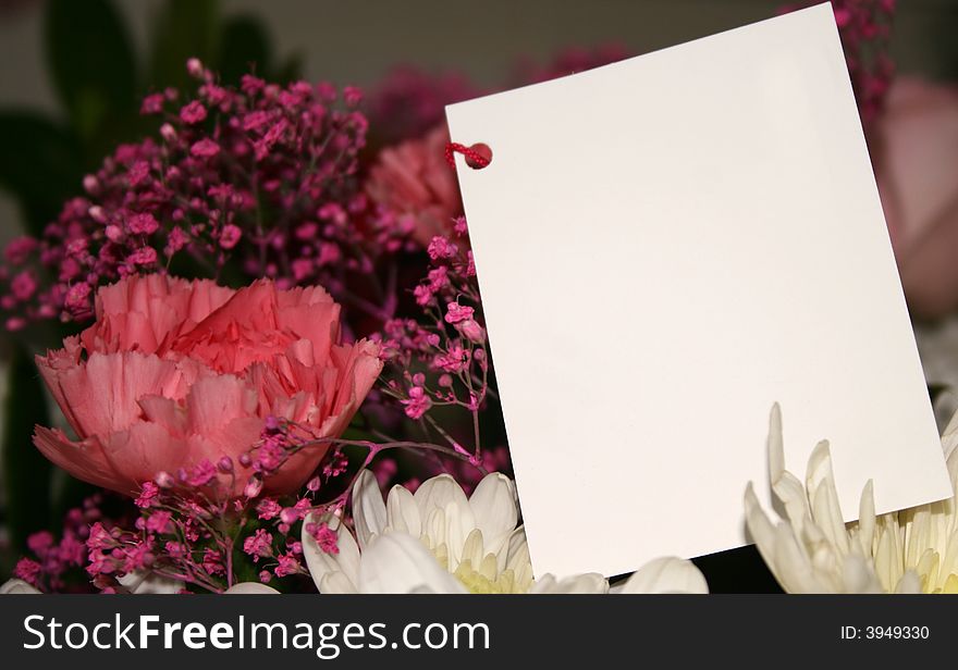 Blank card on a bouquet of flowers. Blank card on a bouquet of flowers