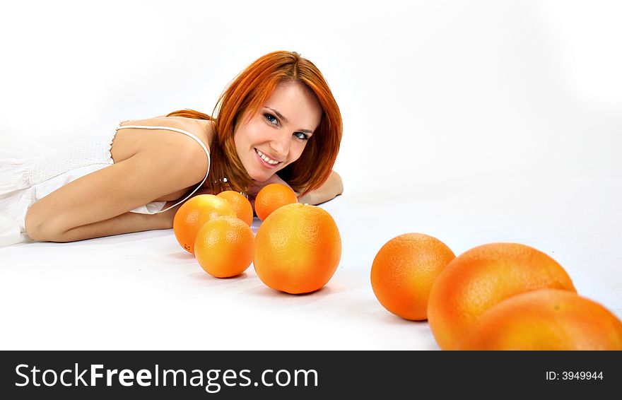 Redhead girl and oranges in studio. Redhead girl and oranges in studio