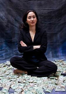Woman Sitting In Money Royalty Free Stock Photos