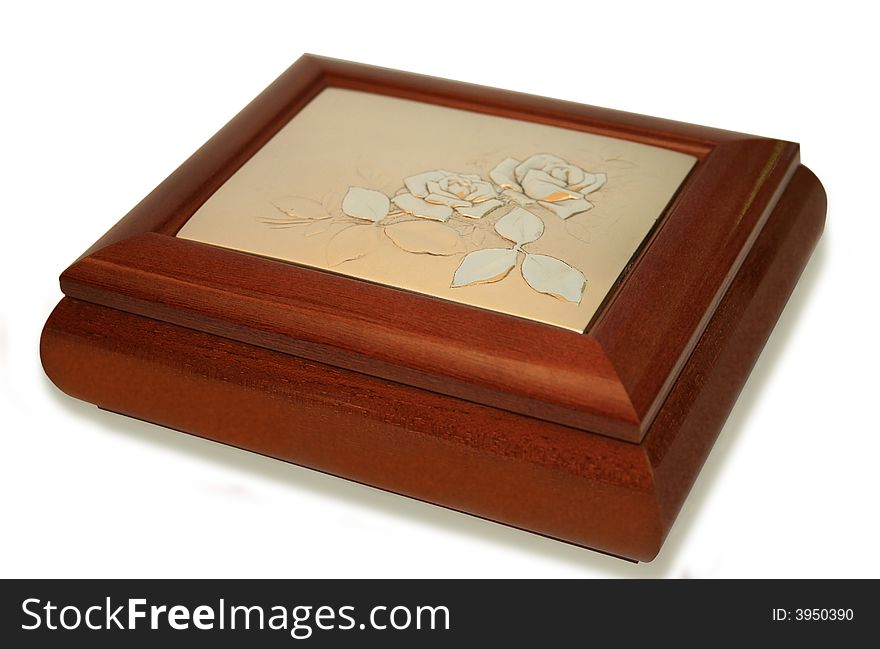 Jeweller ornament in a wooden casket. It is isolated on a white background