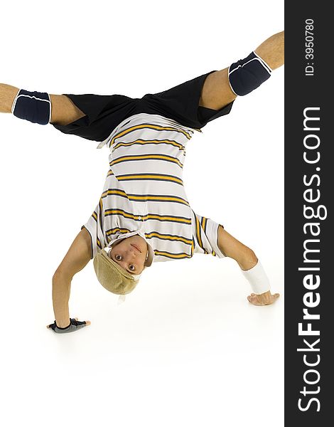 Young bboy standing on hands. Holding legs in air. Looking at camera. Front view, white background. Young bboy standing on hands. Holding legs in air. Looking at camera. Front view, white background