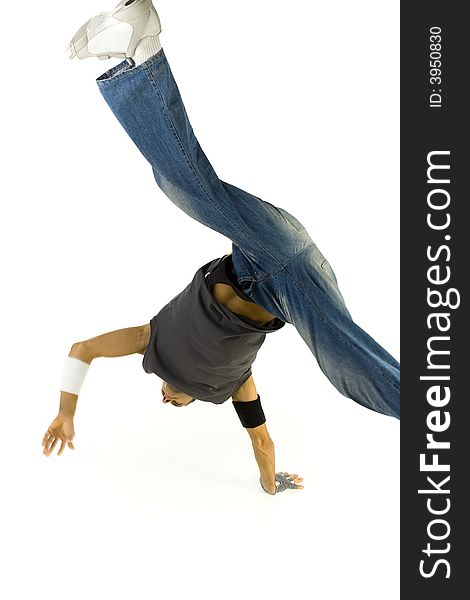 Young bboy standing on one hand with legs astride in air. White background